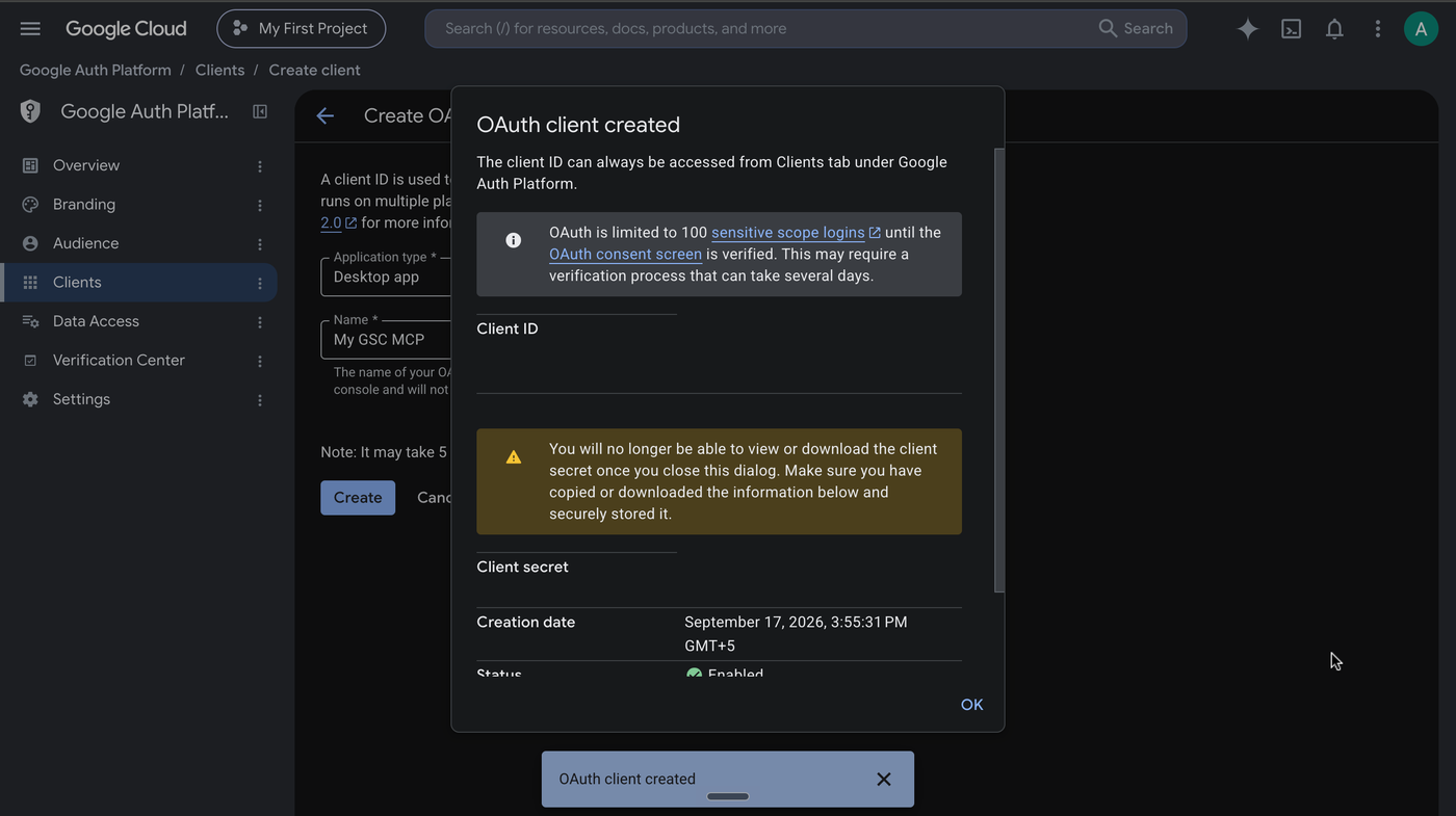 The OAuth client created dialog, with the client ID and client secret redacted, and the warning that the secret cannot be viewed again after closing